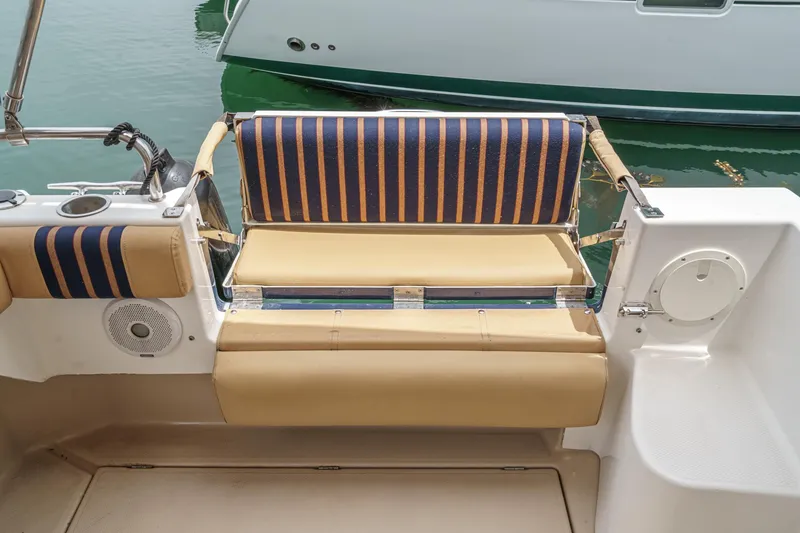 Slide: The Image of 2014 Cutwater C-30 SC LE boat seating area with striped cushions and beige upholstery. - 14