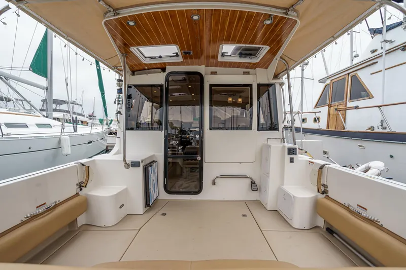 Slide: The Image of 2014 Cutwater C-30 SC LE boat interior with spacious seating and wood-accented ceiling. - 17