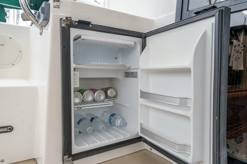 Slide: The Image of Open mini fridge on 2014 Cutwater C-30 SC LE boat, stocked with drinks. - 18