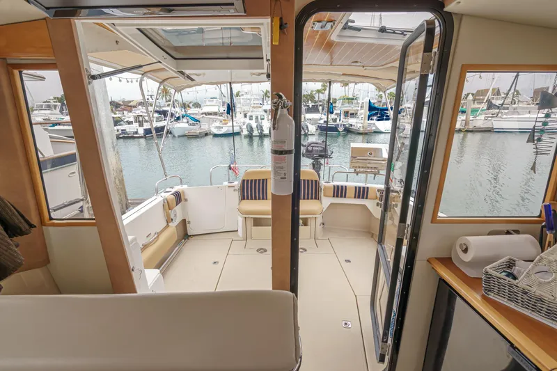 Slide: The Image of Interior view of 2014 Cutwater C-30 SC LE boat with marina background. - 26