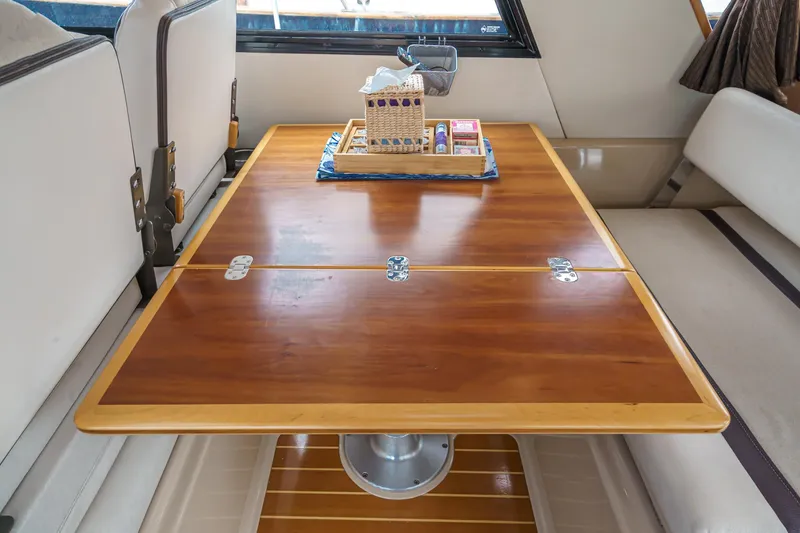Slide: The Image of Interior of 2014 Cutwater C-30 SC LE with wooden table and seating area. - 28