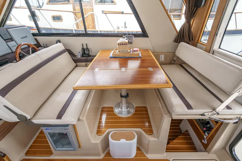 Slide: The Image of Interior of 2014 Cutwater C-30 SC LE boat with dining area and wooden table. - 29