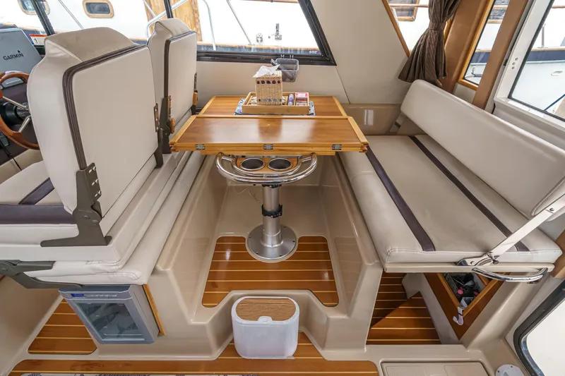 Slide: The Image of Interior of 2014 Cutwater C-30 SC LE boat with seating and wooden table. - 30