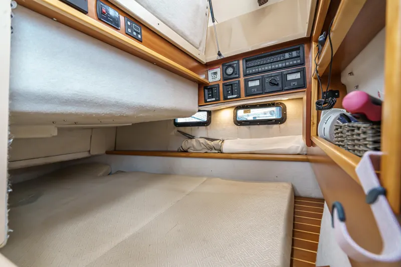 Slide: The Image of 2014 Cutwater C-30 SC LE cabin interior with control panels and cozy sleeping area. - 36