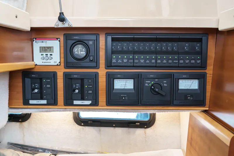 Slide: The Image of Control panel of a 2014 Cutwater C-30 SC LE boat, featuring various switches and gauges. - 37