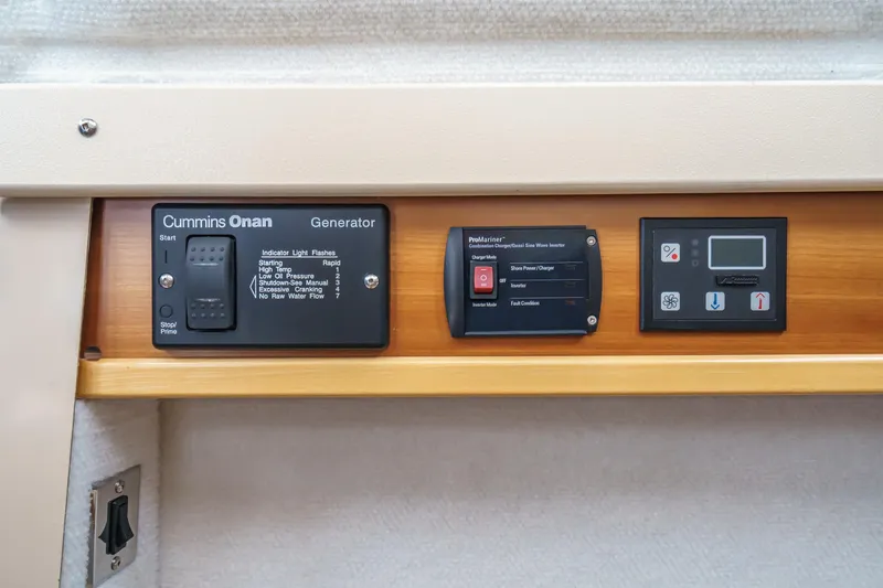 Slide: The Image of Control panel of a 2014 Cutwater C-30 SC LE boat featuring Cummins Onan generator. - 38