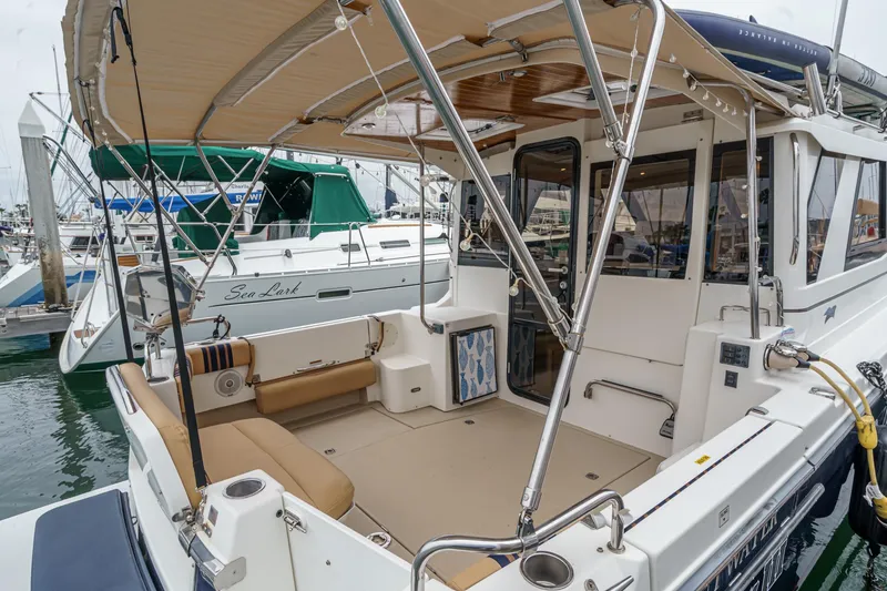 Slide: The Image of 2014 Cutwater C-30 SC LE boat docked, featuring spacious deck and seating area. - 4