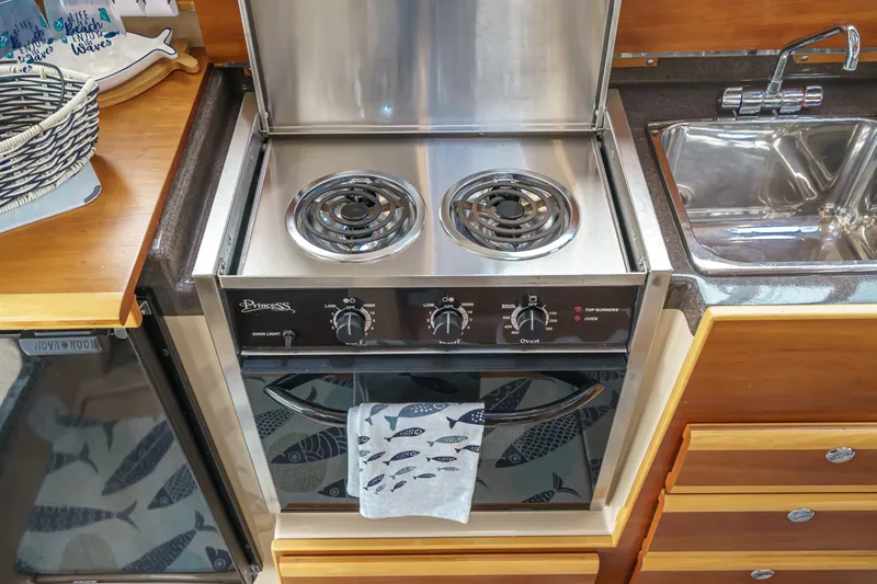 Slide: The Image of Compact kitchen in 2014 Cutwater C-30 SC LE boat with stove, oven, and sink. - 41