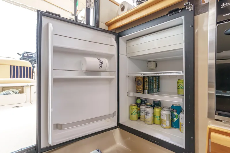 Slide: The Image of Open fridge on 2014 Cutwater C-30 SC LE boat, stocked with beverages. - 43