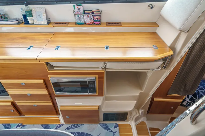 Slide: The Image of Interior of 2014 Cutwater C-30 SC LE boat with wooden cabinetry and built-in microwave. - 45