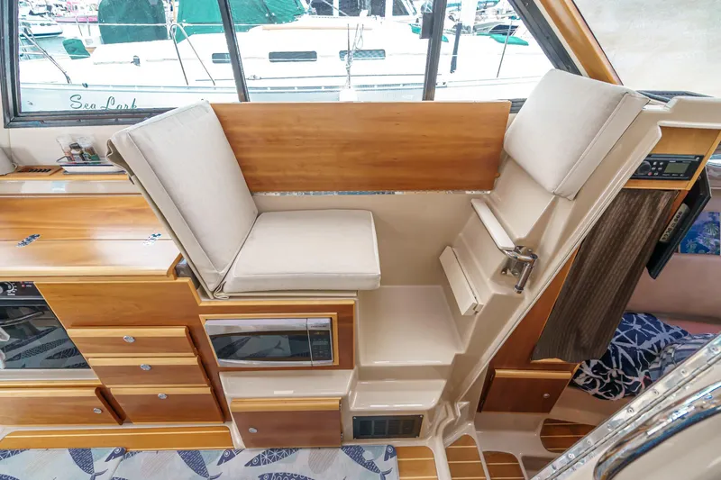 Slide: The Image of 2014 Cutwater C-30 SC LE interior with wooden cabinetry and cushioned seating. - 46