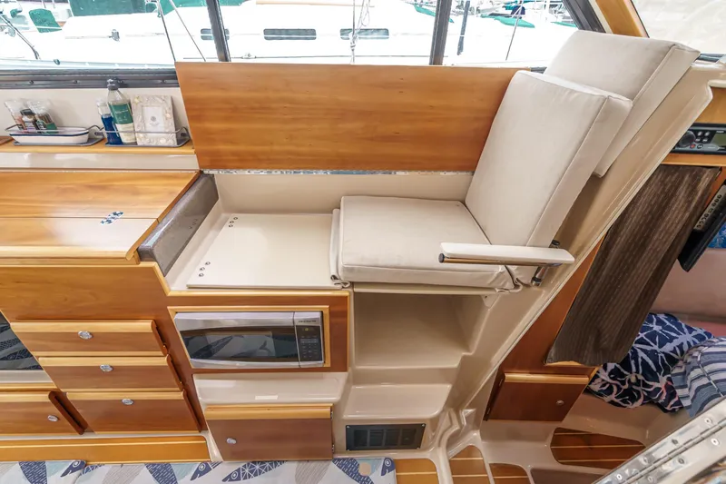 Slide: The Image of Interior of 2014 Cutwater C-30 SC LE boat with wooden cabinetry and cushioned seating. - 47