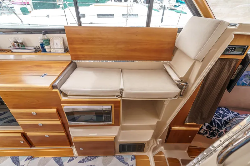Slide: The Image of Interior of 2014 Cutwater C-30 SC LE boat with wooden cabinetry and cushioned seating. - 48