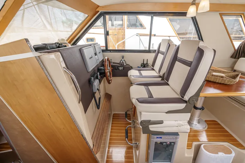 Slide: The Image of Interior of 2014 Cutwater C-30 SC LE boat with helm and seating area. - 49