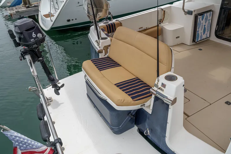Slide: The Image of 2014 Cutwater C-30 SC LE boat with tan seating and striped cushions at a marina. - 6