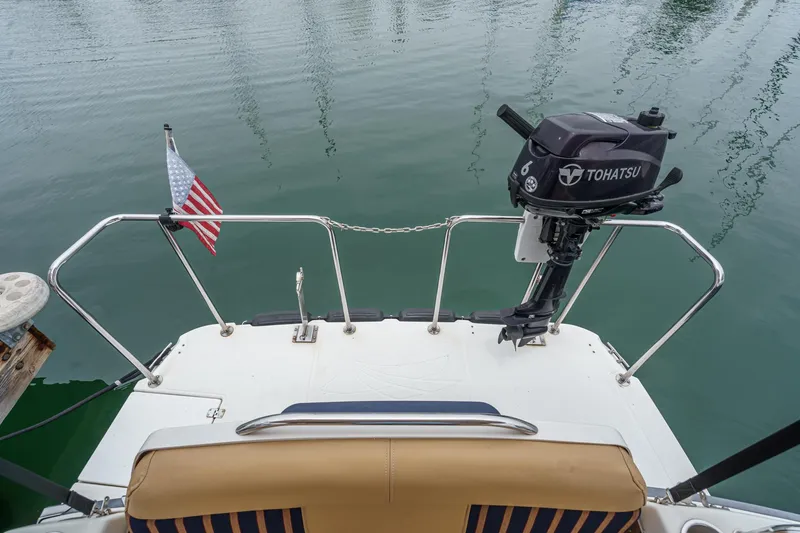 Slide: The Image of 2014 Cutwater C-30 SC LE boat stern with Tohatsu motor and American flag. - 7