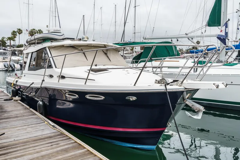 The Image of 2014 Cutwater C-30 SC LE boat docked at marina, surrounded by other vessels. - 0