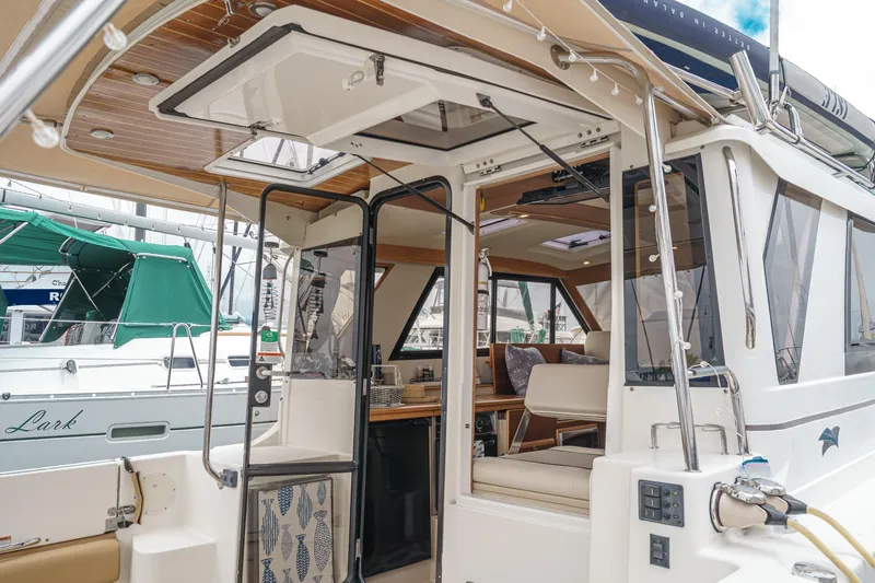 Slide: The Image of 2014 Cutwater C-30 SC LE boat interior with open doors and seating area. - 24