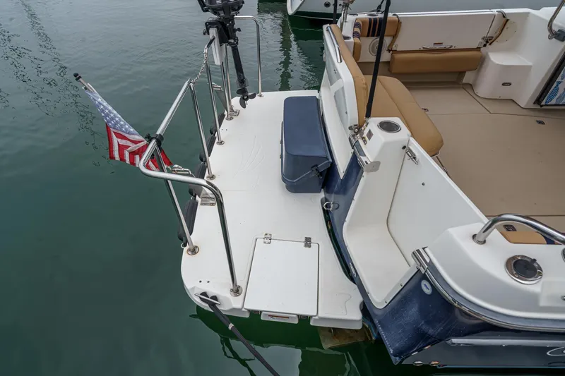 Slide: The Image of 2014 Cutwater C-30 SC LE boat stern with American flag and seating area. - 9