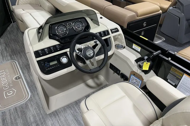 Slide: The Image of 2025 Godfrey Sweetwater 2286 SB boat interior with modern dashboard and steering wheel. - 11