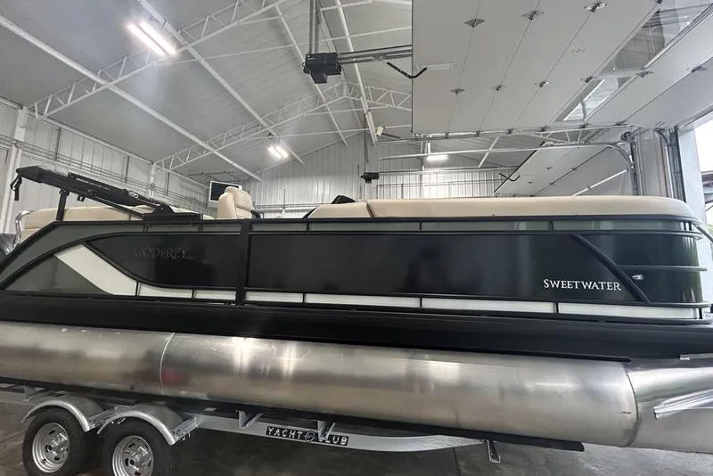 Slide: The Image of 2025 Godfrey Sweetwater 2286 SB pontoon boat in a spacious indoor garage. - 4