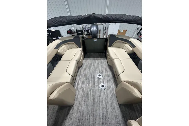 Slide: The Image of 2025 Godfrey Sweetwater 2286 SB boat interior with beige seating and gray flooring. - 8