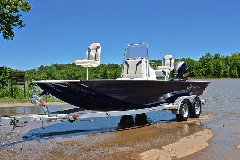 Slide: The Image of 2019 G3 Bay 20 DLX boat on trailer by a lake, clear blue sky. - 10