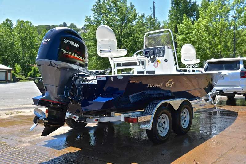 Slide: The Image of 2019 G3 Bay 20 DLX boat with Yamaha motor on trailer, parked outdoors. - 14