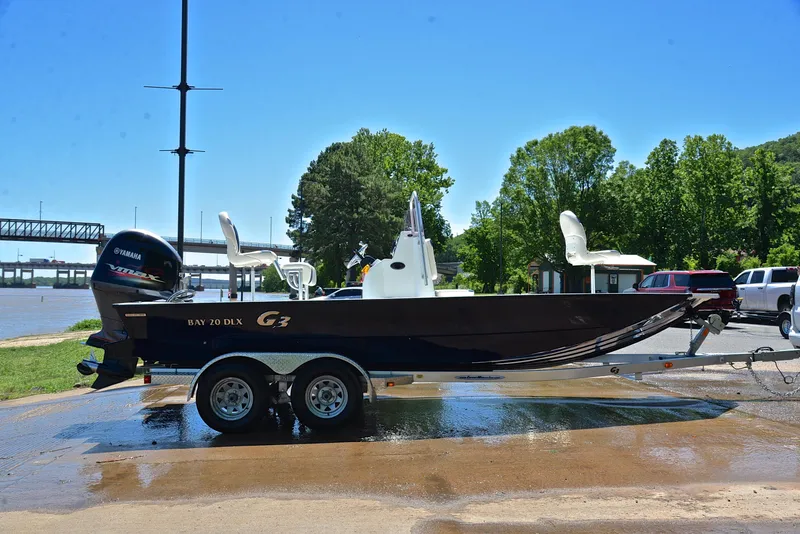 Slide: The Image of 2019 G3 Bay 20 DLX boat on trailer near river, sunny day. - 15