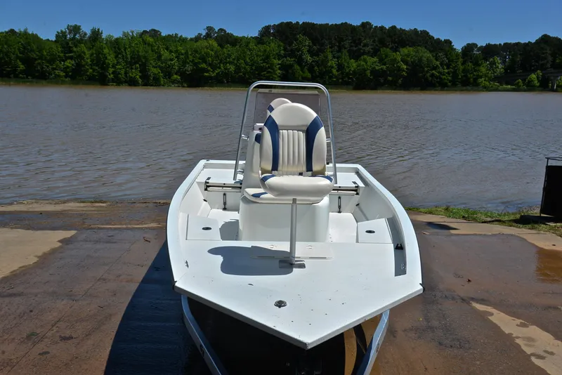 Slide: The Image of 2019 G3 Bay 20 DLX boat on a riverbank under clear blue sky. - 17