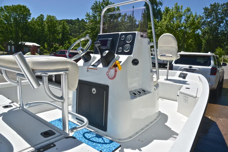 Slide: The Image of 2019 G3 Bay 20 DLX boat interior with steering console and seating, outdoors. - 19
