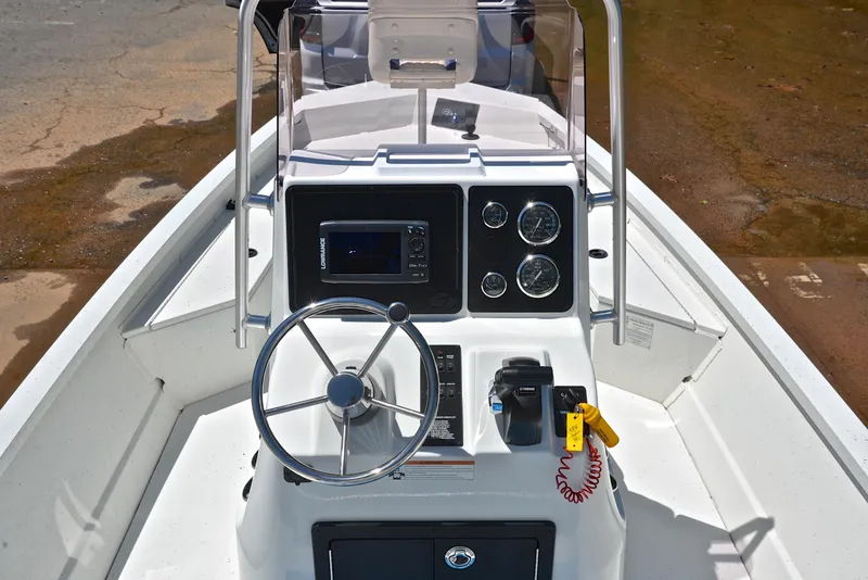 Slide: The Image of 2019 G3 Bay 20 DLX boat console with steering wheel and gauges. - 21