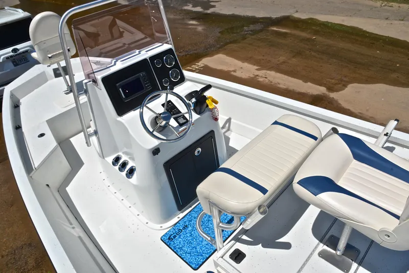 Slide: The Image of 2019 G3 Bay 20 DLX boat interior with steering console and seating. - 23