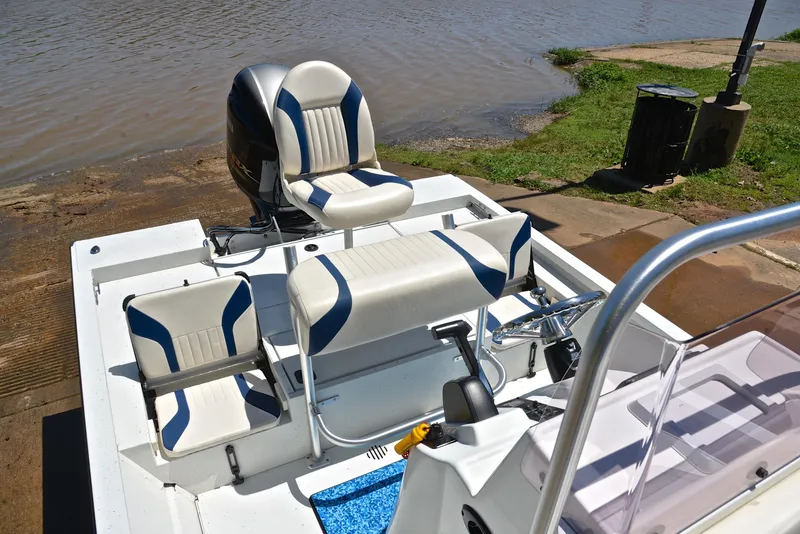 Slide: The Image of 2019 G3 Bay 20 DLX boat with seating and motor, near water's edge. - 24