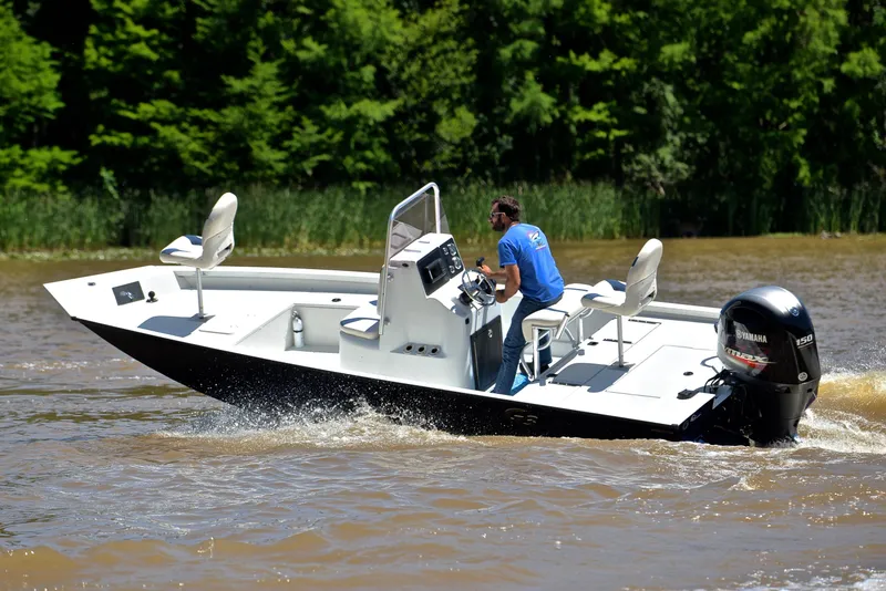 Slide: The Image of 2019 G3 Bay 20 DLX boat cruising on a river with lush green trees in the background. - 6