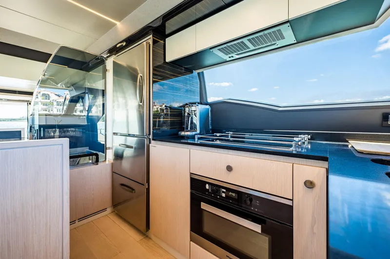 Slide: The Image of Modern kitchen interior of 2017 Azimut 66 yacht with sleek appliances and ocean view. - 14