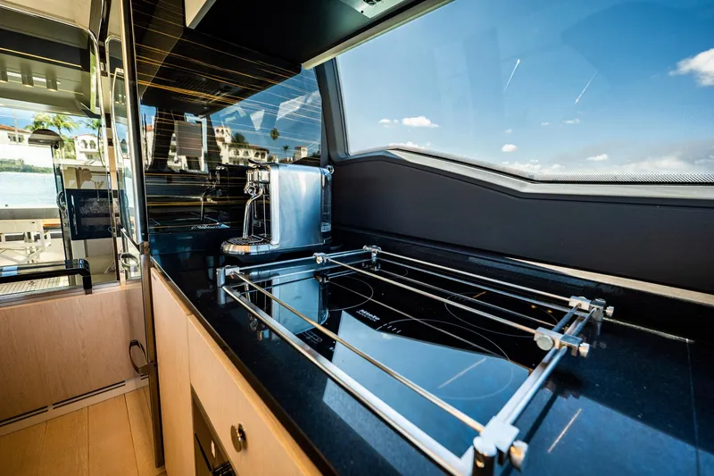 Slide: The Image of Luxurious kitchen interior of 2017 Azimut 66 yacht with sleek black countertops. - 15