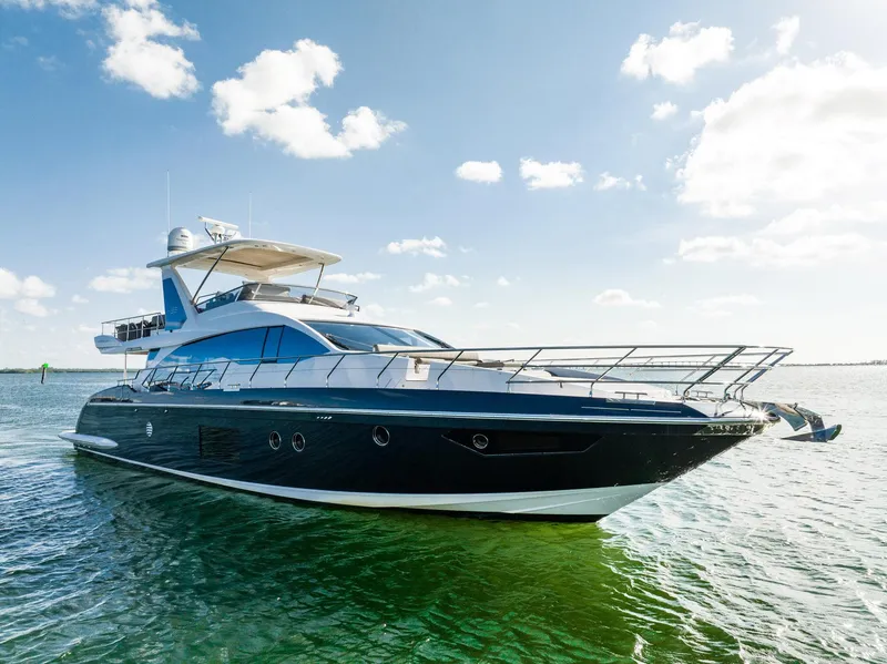 Slide: The Image of Luxurious 2017 Azimut 66 yacht cruising on clear blue waters under a sunny sky. - 2