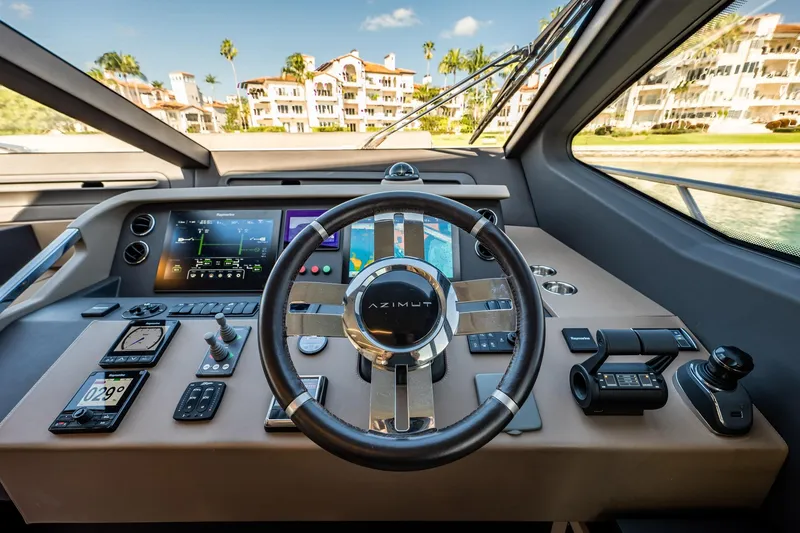 Slide: The Image of Cockpit of 2017 Azimut 66 yacht with modern navigation controls and steering wheel. - 25
