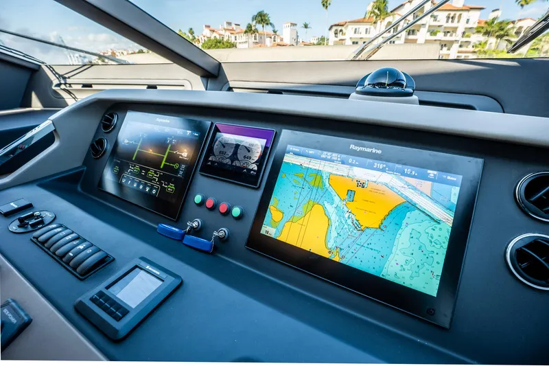 Slide: The Image of Control panel of a 2017 Azimut 66 yacht with navigation screens and controls. - 27
