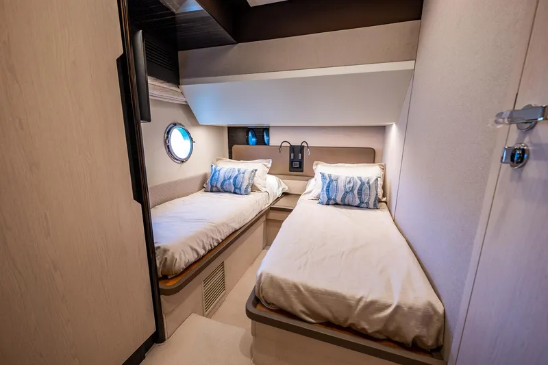 Slide: The Image of Twin cabin interior of 2017 Azimut 66 yacht with modern decor and porthole window. - 36