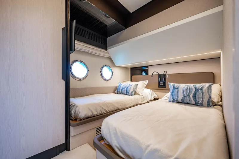 Slide: The Image of Luxurious cabin interior of 2017 Azimut 66 yacht with twin beds and porthole windows. - 37