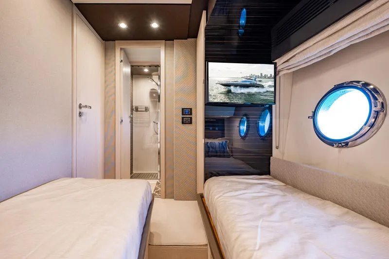 Slide: The Image of Luxurious 2017 Azimut 66 yacht cabin with twin beds and porthole windows. - 38