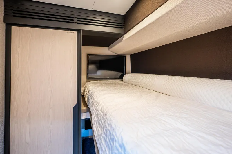 Slide: The Image of Cozy cabin interior of 2017 Azimut 66 yacht with bunk bed and TV. - 39