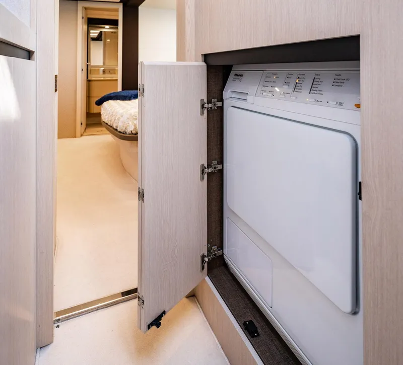 Slide: The Image of Laundry area inside 2017 Azimut 66 yacht, featuring a built-in washing machine. - 41
