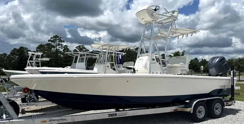Slide: The Image of 2025 Pathfinder 2500 Hybrid boat on trailer under cloudy sky. - 14