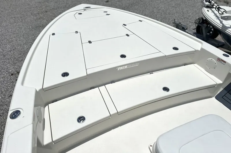 Slide: The Image of 2025 Pathfinder 2500 Hybrid boat deck with storage compartments, white finish, outdoor setting. - 15