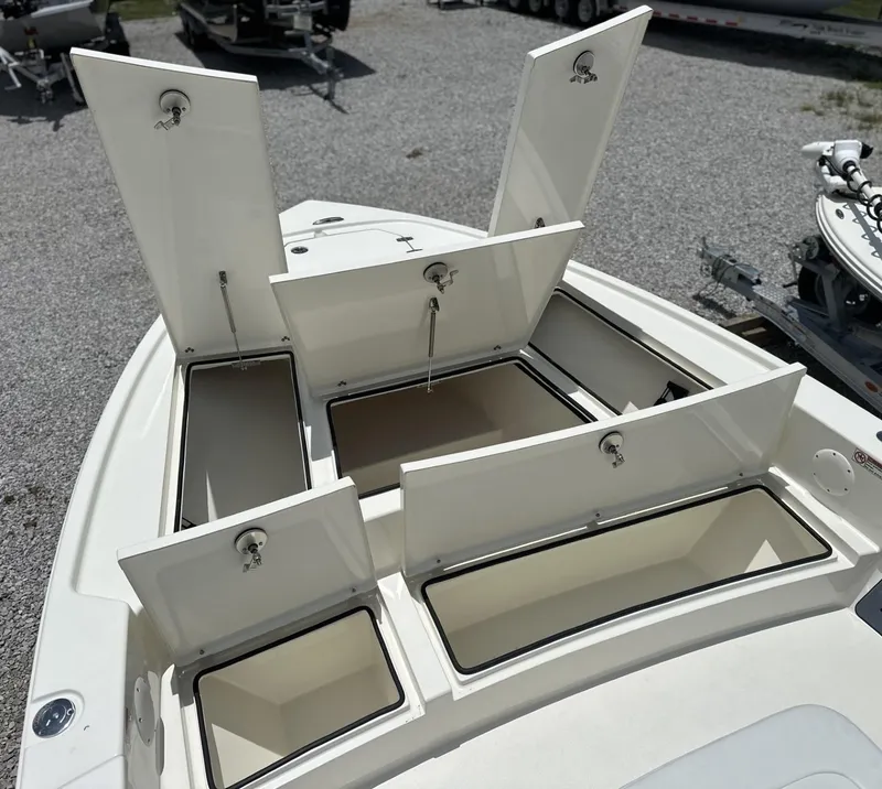 Slide: The Image of Open storage compartments on a 2025 Pathfinder 2500 Hybrid boat deck. - 16