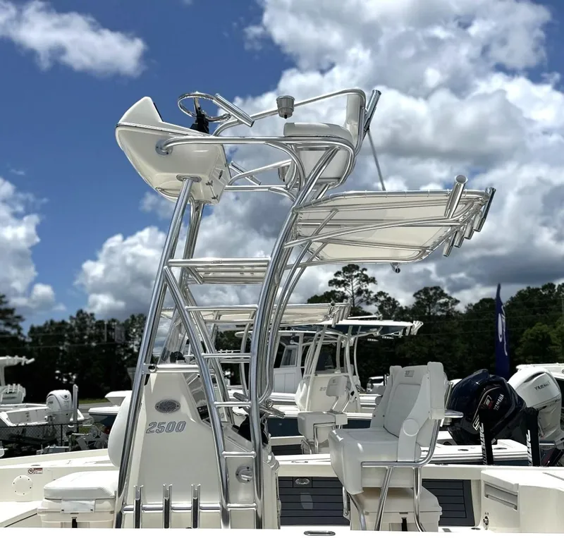Slide: The Image of 2025 Pathfinder 2500 Hybrid boat with elevated seating, under a partly cloudy sky. - 4