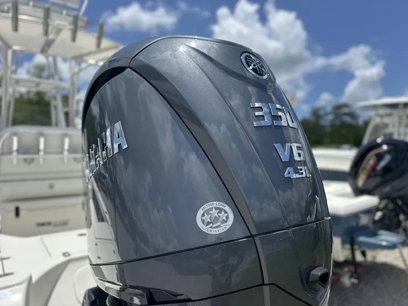 Slide: The Image of Outboard motor on a 2025 Pathfinder 2500 Hybrid boat under a clear blue sky. - 5